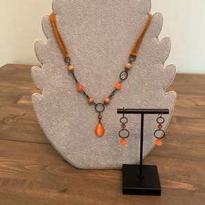 Orange beaded necklace and matching earrings with suede straps. Cute set!